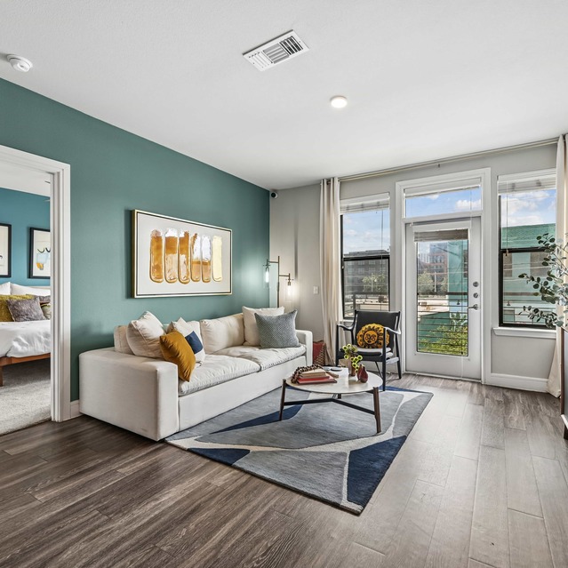 The Arnold - Living Area with Hardwood Floors and Access to Private Patio