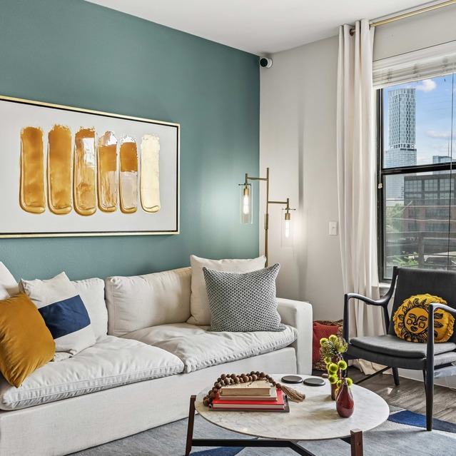 The Arnold - Living Area with Hardwood Floors and Floor to Ceiling Windows 