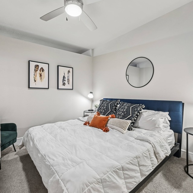 The Arnold - Bedroom with Ceiling Fan and Carpeted Flooring